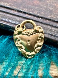 VERY TRENDY!  PERFECT FOR YOUR CHARM NECKLACE! Victorian style brass padlock heart with beautiful detail. These charms are new and unworn, made from decades old stamping machines in the USA. Single-sided with a hollow back, these charms are lightweight, can be worn a variety of ways including as a pendant, earrings, on a bracelet, anklet or on a charm necklace. These charms are made of raw brass which will patina over time and may already have some patina. There may be color variations in the br Brass Heart Pendant Locket Necklace With Vintage Charm, Vintage Brass Heart Pendant Jewelry, Vintage Brass Heart Charm Necklace, Heart-shaped Brass Necklace With Vintage Charm, Heart-shaped Lock Necklace Gift, Romantic Anniversary, Heart Lock, Love Romantic, Vintage Victorian