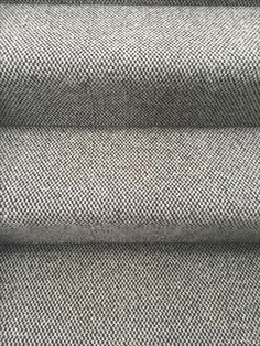 a close up view of the fabric on a stair treading in black and white