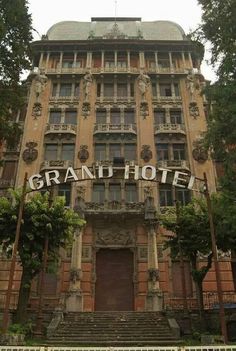 an old building with the words grand hotel written on it's front and side