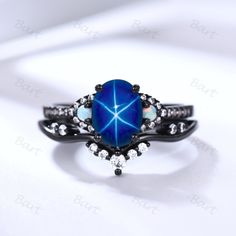 an opal and diamond ring on a white background