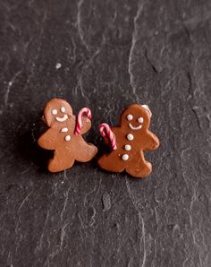 two small gingerbread cookies with candy canes