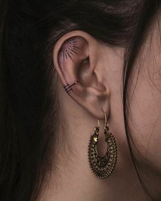 a close up of a person with ear piercings