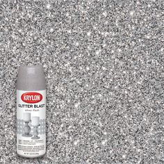 a can of krylon glitter blast is on the ground with silver flakes