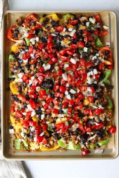 a casserole dish filled with lots of vegetables and seasoning on top of it