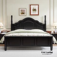 there is a black bed with two lamps on the nightstands and one has a white bedspread