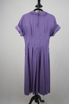 "1950s hand made dress. Purple rayon, plain weave fabric. The weight of the fabric would make a great swing dress. Peter Pan collar and cuffed cap sleeves. Wide, 3\" waist. Waist, collar, and cuffs have stiffening in them. Full skirt is box pleated and has reverse, decorative seaming. (see next to last photo although the color is off in this photo) 3.5\" hem. Fastens in the back with a short metal zipper and another one in the side. Freshly laundered. Excellent condition. There is one small dark 1950s Short Sleeve Dress For Vintage Fashion, 1950s Short Sleeve Vintage Fashion Dress, 1950s Style Vintage Fashion Dress With Short Sleeves, 1950s Style Short Sleeve Vintage Dress, 1950s Style Lined Short Sleeve Dresses, 1950s Style Short Sleeve Lined Dress, Vintage Cap Sleeve Dresses, Solid Color Vintage Cotton Dress, Vintage Solid Color Daywear Dresses