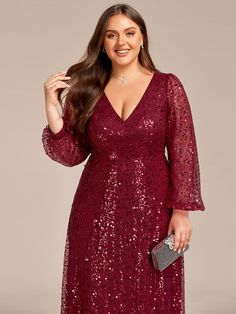 a woman wearing a red sequinned dress with long sleeves and an open v - neck