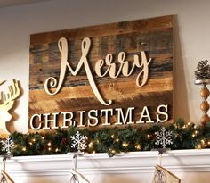 a christmas mantel decorated with stockings and garlands in front of a sign that says merry christmas