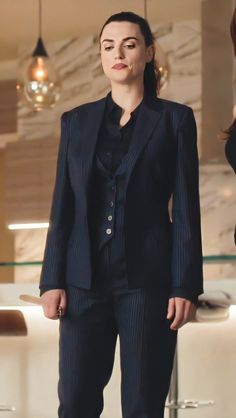 a woman in a black suit and heels