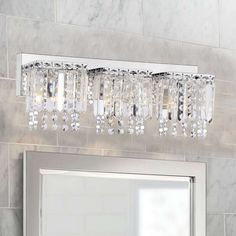 a bathroom vanity with a mirror and lights above it