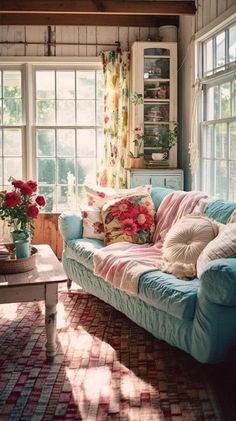 a living room filled with lots of furniture and flowers in vases on the windowsill