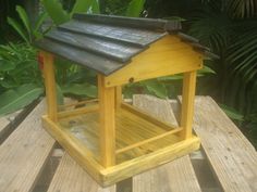 a bird house sitting on top of a wooden table