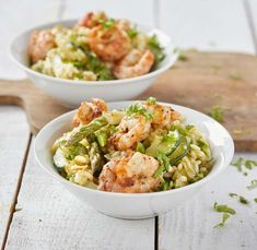 two white bowls filled with pasta and shrimp