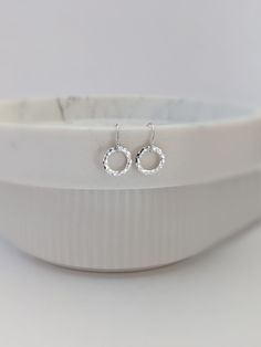 These tiny sterling silver open circles earrings are hammered for a classically simply look. These are perfect for everyday earrings. Hoops are 11mm across. Sterling silver french hook ear wires with a tiny ball at the top. GOLD: https://www.etsy.com/listing/544810673 * Tiny 11mm sterling silver circles * Hammered finish * French hook ear wires with tiny ball at the top  STERLING / FINE SILVER  Sterling silver is a high-quality metal that is 92.5% silver (.925). Some of my items are made with fi Minimalist Hoop Earrings With Halo Design, Everyday Minimalist Earrings With Halo Design, Silver Minimalist Earrings With Halo Design, Minimalist Sterling Silver Halo Earrings, Hammered Open Circle Earrings For Everyday, Single Silver Open Circle Earring, Small Hammered Silver Hoop Earrings, Silver Hammered Open Circle Earrings, Nickel-free Silver Open Circle Earrings