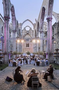 people sitting at tables in an old building