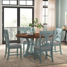 a dinning room table with chairs around it