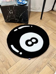 a black and white area rug with an eight - o - clock design on it