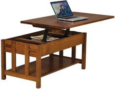 an open laptop computer sitting on top of a wooden table with drawers underneath it,