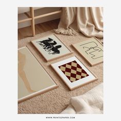 four framed art pieces sitting on the floor