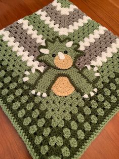 a crocheted blanket with a teddy bear on it