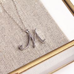 Silver M Pendant / Silver letter M Necklace / Dainty silver chain necklace / initial necklace / sterling silver chain / personalized jewelry Dainty "M" initial. Perfect every day necklace. Lovely gift for your self, sister, bridesmaids, new mom. Pendant: Base metal is brass and silver plated on top. Chain is 18 inches, sterling silver.  Note: model shots might show a different initial, only to illustrate overall look and length of the chain. This listing is for the "M" initial. Letter M Necklace, Every Day Necklace, M Necklace, Word Necklace, Alphabet Necklace, Gold Letter Necklace, Necklace Initial, Party Necklace, Personalized Bridesmaid Gifts