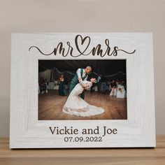 a wooden frame with an image of a bride and groom on the dance floor