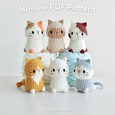 a group of knitted cats sitting next to each other