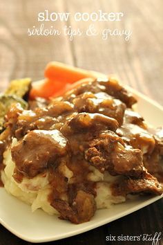 a close up of a plate of food with meat and gravy on it