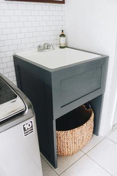 a washer and dryer in a small room with white tile flooring on the walls