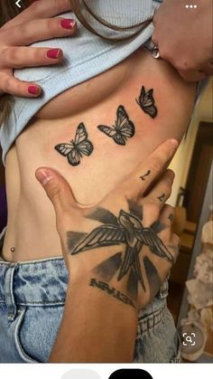 a woman with butterfly tattoos on her stomach and the bottom half of her body is shown