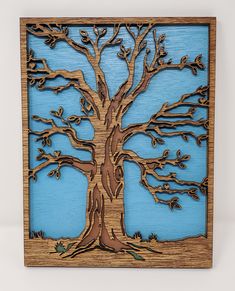 a wooden cutout of a tree with blue sky in the background