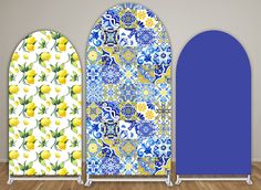 two doors with blue and yellow designs on them, next to each other in front of a white wall