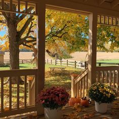 the porch is covered with fall leaves and flowers