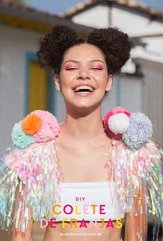 a woman with her eyes closed and two stuffed birds on her shoulders, smiling at the camera