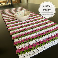 a crocheted table runner with a bowl on it