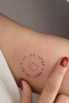 a woman's arm with writing on it that says love is in the air