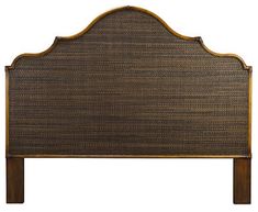 an upholstered headboard with wooden posts and wood trimmings on the sides