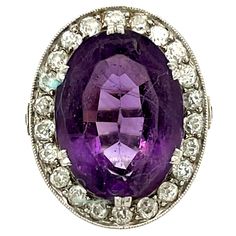 Antique Edwardian platinum diamond oval amethyst ring, circa 1910. This gorgeous ring is beautifully made centering on an oval amethyst with a rich purple hue. The ring has a halo of 26 old European cut diamonds weighing 0.90 carats approximately. The diamonds are H to J color and VS clarity. The ring has a gorgeous platinum gallery underneath the stone. There are numbers on the ring pointing to a fine craftsman or jewelry store made and sold the ring, it is also stamped Platinum. The ring is a Oval Purple Amethyst Ring With 17 Jewels, Art Deco Oval Purple Amethyst Ring, Luxury Oval Amethyst Ring With Center Stone, Oval Amethyst Ring With Diamond Accents, Oval Hallmarked Amethyst Ring In White Gold, Antique Oval Amethyst Ring With Center Stone, Luxury Oval Amethyst Ring With Diamond Accents, Heirloom Style Purple Oval Amethyst Ring, Classic Oval Amethyst Ring With Diamond