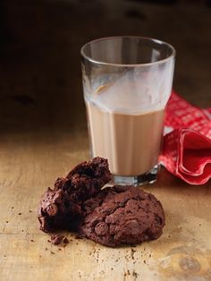 a cookie and glass of milk on a table