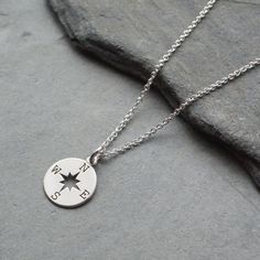 Beautiful necklace a sterling silver compass charm that suspends from a sterling silver trace chain. The compass charm measures 13 mm There is a choice of 14, 16 or 18 inch sterling silver chain. Would make an ideal gift for a loved one that is off to travel or would make a great graduation gift. The necklace will arrive in a gift box. Sterling Silver White Gold Compass Necklace, Sterling Silver White Gold Necklace With Compass Design, Minimalist Round Compass Necklace, Minimalist Compass Design Round Pendant Necklace, Minimalist Round Necklace With Compass Design, Silver Medallion Charm Necklace With Compass Design, Silver Compass Necklace, Compass Necklace Silver, Travel Necklace