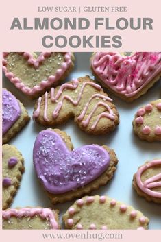 some heart shaped cookies with pink icing on them and the words low sugar gluen free almond flour cookies