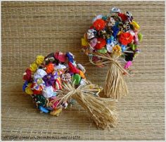 two bouquets of flowers are sitting on the table together, one is tied with twine