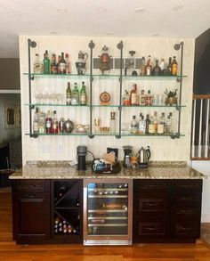 a kitchen with shelves filled with bottles and glasses