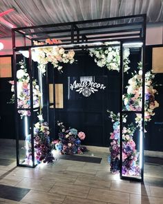 the entrance to an event decorated with flowers