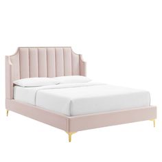 a pink bed with gold legs and headboard