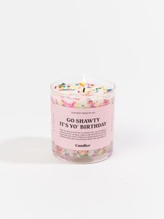 a pink candle with sprinkles on it and the words go shawy it's no birthday