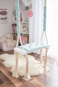 a room with a swing and rugs on the floor