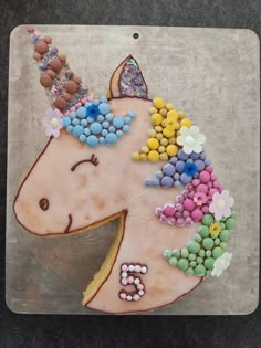 a cake shaped like a unicorn with sprinkles on it