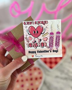 a person holding up a valentine's day card