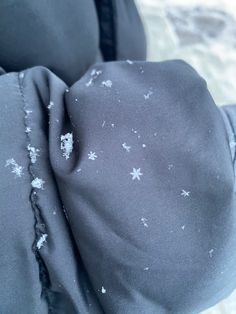 the fabric is covered with snow flakes and has been pulled back to reveal an interesting pattern